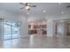 Open concept living room features wood flooring, access to the pool, and a view of the kitchen at 3114 Jemima Ave, The Villages, FL 32163