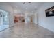 Open concept living room features wood flooring, access to the kitchen, and access to the lanai at 3114 Jemima Ave, The Villages, FL 32163