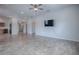 Open concept living room features wood flooring and a mounted television at 3114 Jemima Ave, The Villages, FL 32163