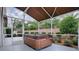 Relaxing hot tub area with a fully screened enclosure and lush tropical landscaping for added privacy at 3114 Jemima Ave, The Villages, FL 32163