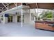 Enclosed outdoor living area with a hot tub, TV, and sliding glass doors leading indoors at 3114 Jemima Ave, The Villages, FL 32163