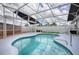 Sparkling pool inside screened enclosure with a meticulously maintained backyard, a perfect blend of relaxation and recreation at 3114 Jemima Ave, The Villages, FL 32163