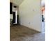 Neutral hallway featuring carpet flooring and white walls, adjacent to the kitchen and other rooms at 708 Lake Shore Dr, Pierson, FL 32180