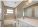 Clean bathroom featuring a bathtub and shower combination, toilet, and white vanity at 27303 Gingerbread Pl, Leesburg, FL 34748