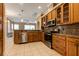 Kitchen with stainless steel appliances, granite countertops, and breakfast bar seating at 27303 Gingerbread Pl, Leesburg, FL 34748