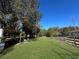Peaceful backyard with a large grassy area and trees at 11635 Se Highway 42, Weirsdale, FL 32195