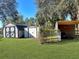 Large backyard with multiple storage sheds at 11635 Se Highway 42, Weirsdale, FL 32195