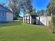 Backyard with two storage sheds and grassy area at 11635 Se Highway 42, Weirsdale, FL 32195