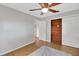 Bedroom with hardwood floors, ceiling fan, and large closet at 11635 Se Highway 42, Weirsdale, FL 32195