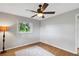 Bedroom with hardwood floors, ceiling fan, and window at 11635 Se Highway 42, Weirsdale, FL 32195