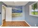 Bedroom with hardwood floors and window at 11635 Se Highway 42, Weirsdale, FL 32195