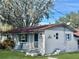 Charming ranch home with a red roof and landscaped lawn at 11635 Se Highway 42, Weirsdale, FL 32195
