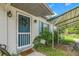 Quaint front door entrance with a covered carport at 11635 Se Highway 42, Weirsdale, FL 32195