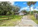 Ranch style home with gated entry and a long driveway at 11635 Se Highway 42, Weirsdale, FL 32195