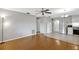 Living room with hardwood floors and kitchen view at 11635 Se Highway 42, Weirsdale, FL 32195