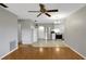 Open concept living room with hardwood floors and kitchen access at 11635 Se Highway 42, Weirsdale, FL 32195
