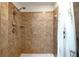 Large shower with tiled walls and shower door at 11635 Se Highway 42, Weirsdale, FL 32195