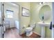 Convenient bathroom features tile floor, pedestal sink, and an adjacent laundry area at 3506 Mulberry Grove Loop, Leesburg, FL 34748