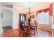 Elegant dining room with wood floors, classic chandelier, and a china cabinet at 3506 Mulberry Grove Loop, Leesburg, FL 34748