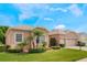 Charming single-story home featuring a well-manicured lawn and a two-car garage at 3506 Mulberry Grove Loop, Leesburg, FL 34748
