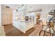 Bright kitchen with white cabinets, granite counters, and modern appliances at 3506 Mulberry Grove Loop, Leesburg, FL 34748