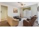 Comfortable living room featuring a ceiling fan, plush furniture, soft carpet, and plenty of natural light at 3506 Mulberry Grove Loop, Leesburg, FL 34748