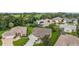 Aerial view of a well-maintained home with green lawn and landscaping in a tranquil neighborhood at 1306 De La Garza Pl, The Villages, FL 32162