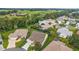 Aerial view of a home featuring a well-kept lawn and landscaping within a quiet neighborhood at 1306 De La Garza Pl, The Villages, FL 32162