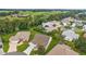 Panoramic aerial view of a home nestled in a picturesque neighborhood surrounded by lush greenery at 1306 De La Garza Pl, The Villages, FL 32162