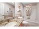 Bathroom with granite countertop and tub with shower and colorful curtain at 1306 De La Garza Pl, The Villages, FL 32162