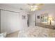 Bright bedroom with a ceiling fan, closet, and drawers at 1306 De La Garza Pl, The Villages, FL 32162