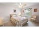 Comfortable bedroom showing a ceiling fan, soft carpet and natural light at 1306 De La Garza Pl, The Villages, FL 32162