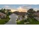Charming single-story home with a well-manicured lawn, a two-car garage, and mature trees, offering curb appeal and a welcoming atmosphere at 1306 De La Garza Pl, The Villages, FL 32162