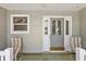 Close up of the front porch with seating and decorative details, creating a charming and inviting entrance to the home at 1306 De La Garza Pl, The Villages, FL 32162