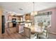 Spacious kitchen with modern appliances and a dining area, perfect for gatherings and everyday meals at 1306 De La Garza Pl, The Villages, FL 32162