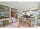 Enclosed lanai with seating, ceiling fans, and access to the backyard at 1306 De La Garza Pl, The Villages, FL 32162