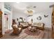 Inviting living room showing wicker furniture, wooden floors and a ceiling fan at 1306 De La Garza Pl, The Villages, FL 32162