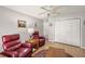 Bright living room with a ceiling fan, seating, and closet at 1306 De La Garza Pl, The Villages, FL 32162