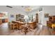 Open living room showcasing wicker furniture, hardwood floors, and natural light at 1306 De La Garza Pl, The Villages, FL 32162