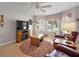 Cozy living room features a fireplace, ceiling fan and bay window at 1306 De La Garza Pl, The Villages, FL 32162