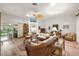 Bright living room boasting wicker furniture, hardwood floors, and access to the outdoor living area at 1306 De La Garza Pl, The Villages, FL 32162