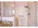Walk-in shower featuring a built in seat, grab bar, and showerhead with handheld wand at 1306 De La Garza Pl, The Villages, FL 32162