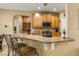 Kitchen boasts granite countertops, wood cabinets, and breakfast bar at 15921 Hanson View Dr, Tavares, FL 32778