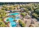 An aerial view capturing the community pool area, lush landscaping, and surrounding residential properties at 27227 Roanoke Dr, Leesburg, FL 34748