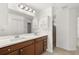Bathroom featuring double vanity, large mirror, and ample cabinet space at 27227 Roanoke Dr, Leesburg, FL 34748