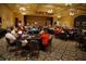 Large community hall with tables, chairs, stage, and decorative carpet at 27227 Roanoke Dr, Leesburg, FL 34748