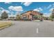 Community entrance with a gate, landscaping, and signage at 27227 Roanoke Dr, Leesburg, FL 34748