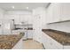 Updated kitchen with granite countertops, stainless steel appliances, and ample cabinetry at 27227 Roanoke Dr, Leesburg, FL 34748