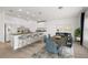 Modern kitchen with breakfast bar, white cabinetry, stainless appliances, and dining area at 27227 Roanoke Dr, Leesburg, FL 34748