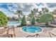 Inviting pool area with a hot tub surrounded by lush landscaping and comfortable lounge chairs at 27227 Roanoke Dr, Leesburg, FL 34748